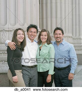 Stock Photography - two young women 
and two young 
men standing outdoors. 
fotosearch - search 
stock photos, 
pictures, images, 
and photo clipart