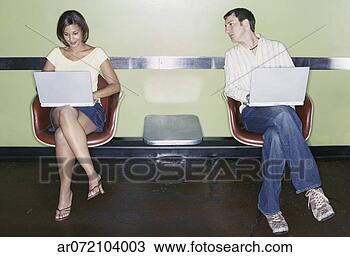 Stock Photo - young couple sitting 
working on laptops. 
fotosearch - search 
stock photos, 
pictures, images, 
and photo clipart