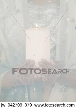 Stock Photograph - young woman holding 
a lit candle. 
fotosearch - search 
stock photos, 
pictures, images, 
and photo clipart