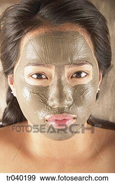 Stock Photograph - young woman lying 
with a mud facial 
mask. fotosearch 
- search stock 
photos, pictures, 
images, and photo 
clipart