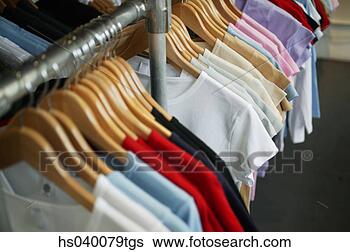 Stock Photo - clothes hanging 
on hangers in 
a shop. fotosearch 
- search stock 
photos, pictures, 
images, and photo 
clipart