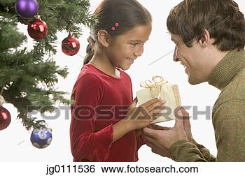 Stock Photo - father giving 
his daughter a 
christmas present. 
fotosearch - search 
stock photos, 
pictures, images, 
and photo clipart