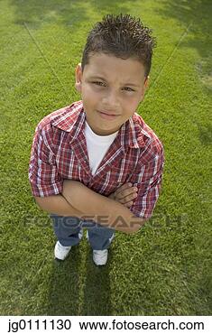 Stock Photography - high angle view 
of a young boy 
standing on a 
lawn with his 
arms folded. fotosearch 
- search stock 
photos, pictures, 
images, and photo 
clipart