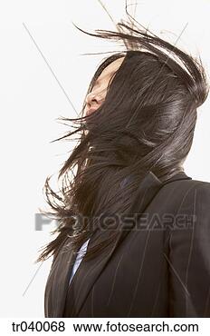 Stock Photo - low angle view 
of a young businesswoman 
with her hair 
blowing over. 
fotosearch - search 
stock photos, 
pictures, images, 
and photo clipart