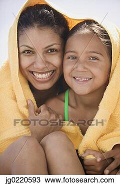 Stock Photo - mother and daughter 
sitting together 
wrapped in a towel. 
fotosearch - search 
stock photos, 
pictures, images, 
and photo clipart