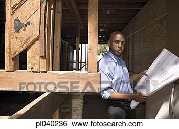 Stock Photo - portrait of a 
mid adult man 
standing leaning 
against a wooden. 
fotosearch - search 
stock photos, 
pictures, images, 
and photo clipart
