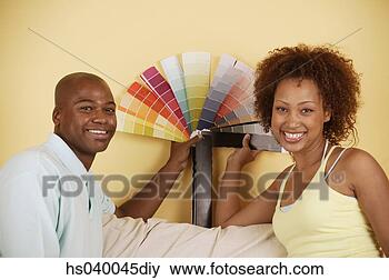 Stock Photo - portrait of a 
young couple holding 
color swatches. 
fotosearch - search 
stock photos, 
pictures, images, 
and photo clipart