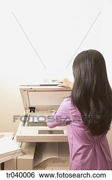 Stock Photo - rear view of a 
young businesswoman 
using a copying 
machine. fotosearch 
- search stock 
photos, pictures, 
images, and photo 
clipart