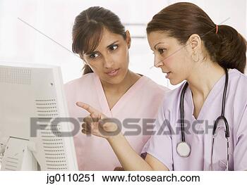 Stock Photography - two nurses discussing 
in front of a 
computer monitor. 
fotosearch - search 
stock photos, 
pictures, images, 
and photo clipart