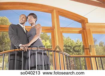 Stock Photo - young couple standing 
on a balcony. 
fotosearch - search 
stock photos, 
pictures, images, 
and photo clipart