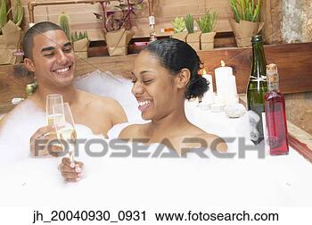 Stock Photography - young couple together 
in a bubble bath 
toasting with 
champagne. fotosearch 
- search stock 
photos, pictures, 
images, and photo 
clipart