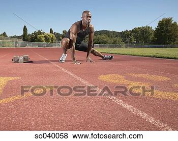Stock Photo - young man stretching 
on a running track. 
fotosearch - search 
stock photos, 
pictures, images, 
and photo clipart