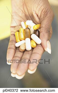 Stock Photo - young woman's 
hand holding medicine 
capsules. fotosearch 
- search stock 
photos, pictures, 
images, and photo 
clipart