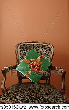 Stock Photo - gift on a leopard 
skin chair. fotosearch 
- search stock 
photos, pictures, 
images, and photo 
clipart