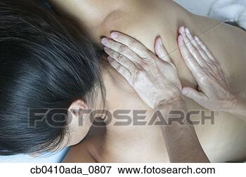 Picture - high angle view 
of a young woman 
getting a massage 
in a health spa. 
fotosearch - search 
stock photos, 
pictures, images, 
and photo clipart