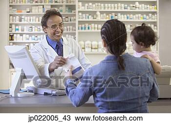 Stock Photo - pharmacist giving 
medication to 
a mid adult woman. 
fotosearch - search 
stock photos, 
pictures, images, 
and photo clipart