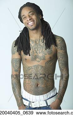 Stock Photograph - portrait of a 
young man standing 
bare cheated with 
tattoos. fotosearch 
- search stock 
photos, pictures, 
images, and photo 
clipart