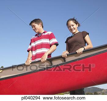 Stock Photo - young couple holding 
a row boat and 
smiling. fotosearch 
- search stock 
photos, pictures, 
images, and photo 
clipart