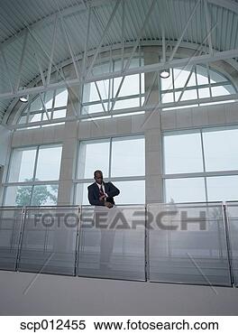 Stock Image - businessman looking 
at his wristwatch. 
fotosearch - search 
stock photos, 
pictures, images, 
and photo clipart