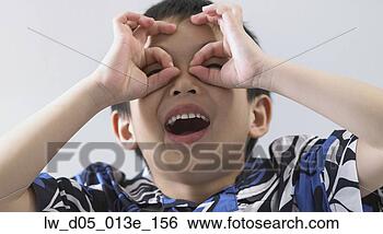 Stock Photo - close-up of a 
boy pretending 
to wear glasses. 
fotosearch - search 
stock photos, 
pictures, images, 
and photo clipart