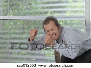 Stock Photo - close-up of a 
businessman clenching 
his teeth in anger. 
fotosearch - search 
stock photos, 
pictures, images, 
and photo clipart