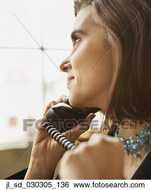 Stock Photo - close-up of a 
businesswoman 
holding a telephone 
receiver. fotosearch 
- search stock 
photos, pictures, 
images, and photo 
clipart