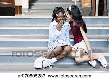 Picture - close-up of a 
girl whispering 
into girl's ear. 
fotosearch - search 
stock photos, 
pictures, images, 
and photo clipart
