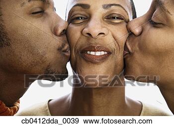 Stock Photograph - close-up of a 
mid adult woman 
being kissed by 
a young man and 
a young. fotosearch 
- search stock 
photos, pictures, 
images, and photo 
clipart