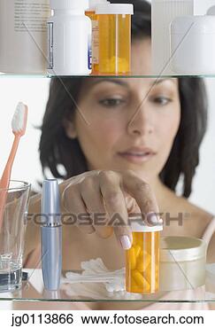 Stock Photo - close-up of a 
mid adult woman 
taking a bottle 
of pills from 
a. fotosearch 
- search stock 
photos, pictures, 
images, and photo 
clipart