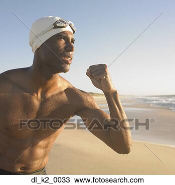 Stock Photo - close-up of a 
young man showing 
his fist on the 
beach. fotosearch 
- search stock 
photos, pictures, 
images, and photo 
clipart