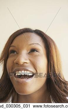 Stock Photography - close-up of a 
young woman looking 
up and laughing. 
fotosearch - search 
stock photos, 
pictures, images, 
and photo clipart