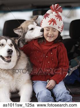 Stock Photography - girl sitting with 
her sled dogs. 
fotosearch - search 
stock photos, 
pictures, images, 
and photo clipart