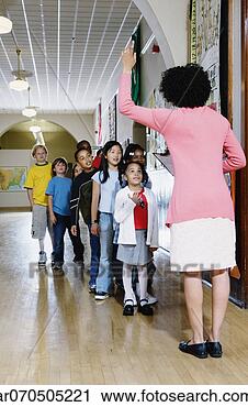 Stock Photography - group of students 
standing in a 
row with a female 
teacher standing 
in. fotosearch 
- search stock 
photos, pictures, 
images, and photo 
clipart