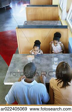 Stock Photograph - high angle view 
of a family sitting 
in a restaurant. 
fotosearch - search 
stock photos, 
pictures, images, 
and photo clipart