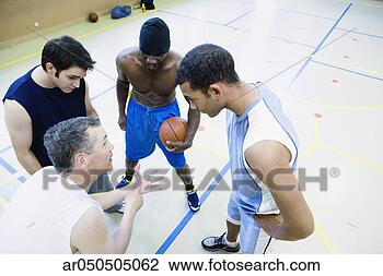 Stock Photo - high angle view 
of a group of 
basketball players 
discussing in 
a. fotosearch 
- search stock 
photos, pictures, 
images, and photo 
clipart