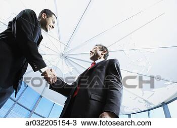 Stock Photo - low angle view 
of two businessmen 
shaking hands. 
fotosearch - search 
stock photos, 
pictures, images, 
and photo clipart