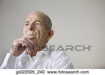 Stock Photography - low angle view 
of a senior man 
looking pensive. 
fotosearch - search 
stock photos, 
pictures, images, 
and photo clipart