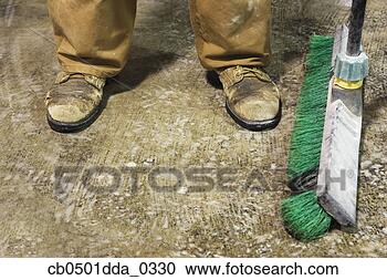 Stock Photography - low section view 
of a male construction 
worker with a 
mop. fotosearch 
- search stock 
photos, pictures, 
images, and photo 
clipart