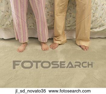 Stock Image - low section view 
of two people 
standing together. 
fotosearch - search 
stock photos, 
pictures, images, 
and photo clipart