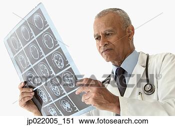Stock Photography - male doctor looking 
at ct scan. fotosearch 
- search stock 
photos, pictures, 
images, and photo 
clipart