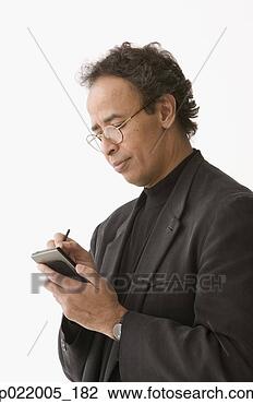 Stock Photo - mature man operating 
a personal data 
assistant. fotosearch 
- search stock 
photos, pictures, 
images, and photo 
clipart