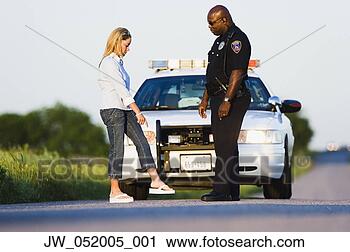 Stock Photography - mid adult woman 
and a police officer 
standing on the 
highway in front. 
fotosearch - search 
stock photos, 
pictures, images, 
and photo clipart