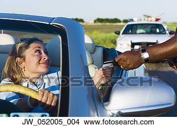 Stock Photo - mid adult woman 
giving her driver's 
license to a police 
officer. fotosearch 
- search stock 
photos, pictures, 
images, and photo 
clipart