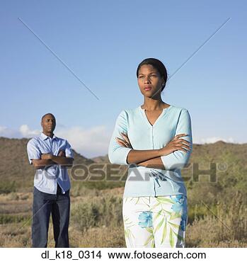 Stock Photo - mid adult woman 
and a mid adult 
man standing with 
their arms crossed. 
fotosearch - search 
stock photos, 
pictures, images, 
and photo clipart