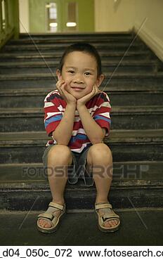 Stock Photo - portrait of a 
boy sitting on 
steps. fotosearch 
- search stock 
photos, pictures, 
images, and photo 
clipart