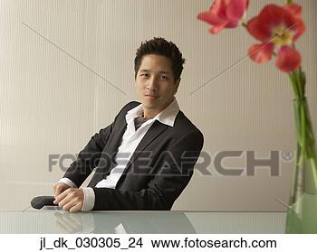 Stock Photo - portrait of a 
businessman sitting 
on a chair in 
an office. fotosearch 
- search stock 
photos, pictures, 
images, and photo 
clipart