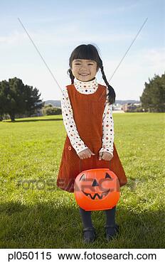 Stock Image - portrait of a 
girl holding a 
halloween lantern. 
fotosearch - search 
stock photos, 
pictures, images, 
and photo clipart