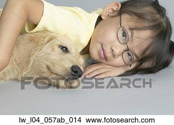 Stock Photo - portrait of a 
girl lying with 
her dog. fotosearch 
- search stock 
photos, pictures, 
images, and photo 
clipart