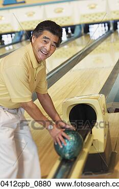 Stock Photography - portrait of a 
mature man taking 
a bowling ball 
from a channel 
in a. fotosearch 
- search stock 
photos, pictures, 
images, and photo 
clipart