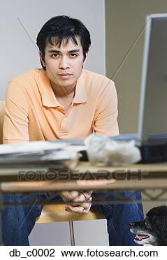 Stock Photo - portrait of a 
mid adult man 
sitting in front 
of a laptop. fotosearch 
- search stock 
photos, pictures, 
images, and photo 
clipart
